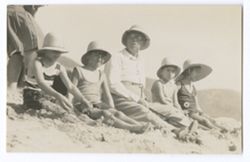 Item 0460. Two scenes of President Rubio seated on the sand. Seated with two children on either side of him.