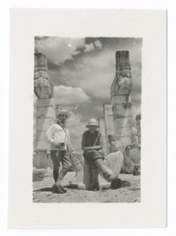 Item 1032. Two unidentified men (one at left possibly Kimbrough) in front of the upper level entrance of the Temple of the Warriors. Man at right seated on Chac-Mool, same man also seen in Items 1050-1056a below.
