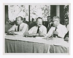 Jack R. Howard with companions at a meeting