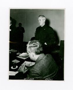 Roy Howard stands in a meeting 2