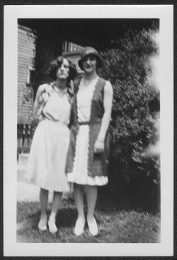 Georgia and Martha Carmichael standing next to house.