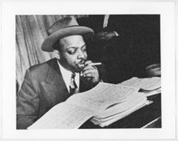 Count Basie with sheet music [archive photograph]