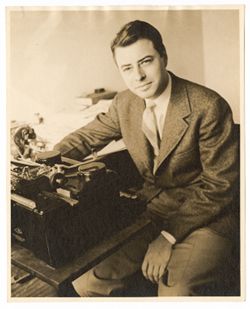 Coughlan seated behind typewriter