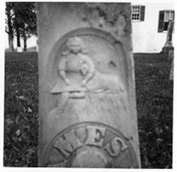 Boy in period clothes [illegible] him - [illegible], one leg tucked under, lamb. whole monument