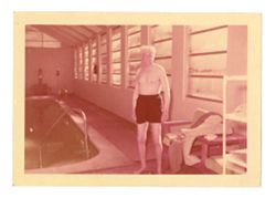 Man by indoor swimming pool