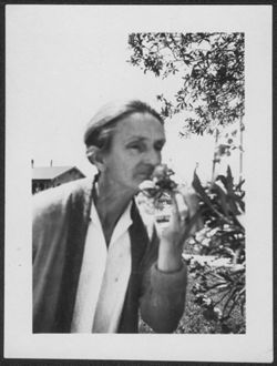 Lida Carmichael smelling a flower in West Palm Beach, Florida.