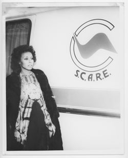 Diahann Carroll in front of vehicle with S.C.A.R.E. logo