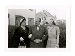 Peggy Howard with couple in back yard