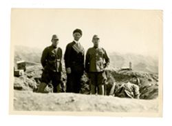 Men pose by dead soldier(?)
