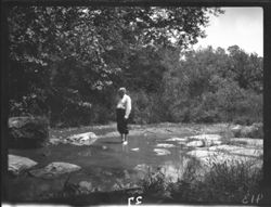 Mr. Woollen in midst of stream, barefooted