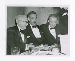 Roy Howard and other men dining at an event