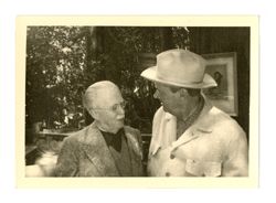 Roy Howard talking with another man
