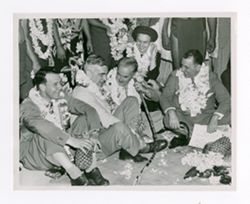 Roy Howard and company sitting on ground