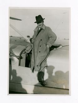 Roy Howard posing beside an aircraft