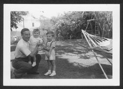 Hoagy Carmichael, Randy and Hoagy Bix Carmichael in a backyard with a swing set and hammock.