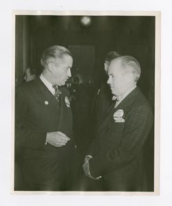 Roy Howard talking with another man