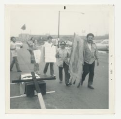 Group protesting with signs and cross