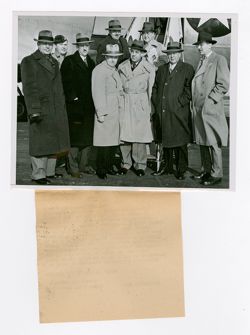 Roy Howard and others standing outside of an airplane
