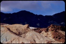 Colored rock masses against background of east slope of Black Mtns. Death Valley