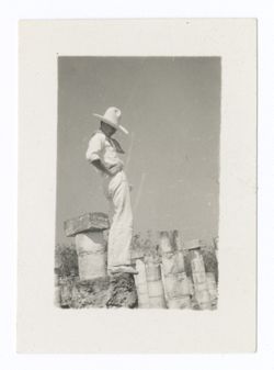Item 1019. Unidentified man wearing sombrero standing on wall above colonnade.