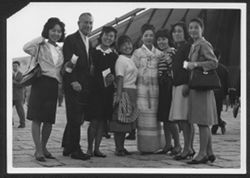Hoagy Carmichael in Japan posing with seven unidentified women.