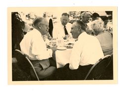 Men talk at table