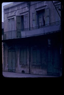 Gray plaster wall with closed green shutters 830 Royal St. New Orleans