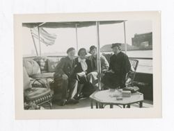 Roy Howard and women on a boat