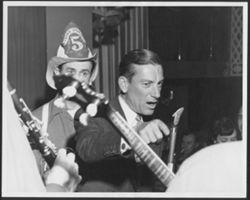 Hoagy Carmichael on stage with band members.