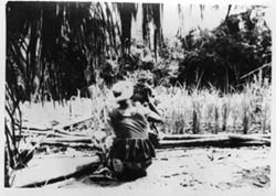 Women attending to a baby on a rice farm