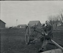 Man and horse-drawn farm equipment