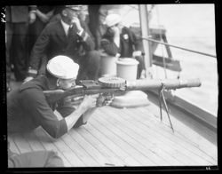 Sailor firing artillery