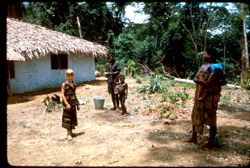 Young girl poses as villagers watch