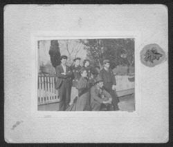 Howard Carmichael with two unidentified men and three women posing on street side, ca. 1897.