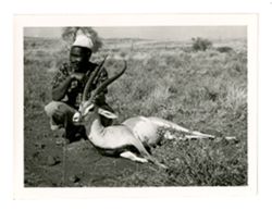 Hunting guide holding dead Grant's gazelle