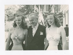 Roy Howard posing with two women
