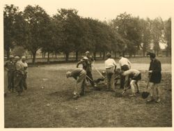Prisoners clearing a ball field