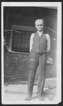 Pa Robison standing in front of a house.