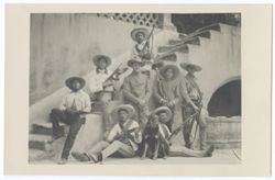 Item 28. Group of armed men surrounding Julio Saldivar (in uniform) in courtyard of Hacienda.