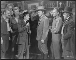 Hoagy Carmichael with a group of men, including Lloyd Bridges and Dana Andrews, in a scene from the film Canyon Passage.