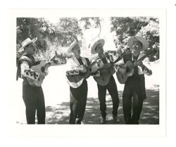 Group of men playing guitar and singing