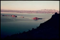 T-15= LAKE MEAD AND MOUNTAINS IN LIGHT OF SETTING SUN. CUSHMAN