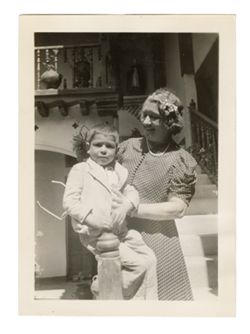 Peg Howard posing for photograph with child