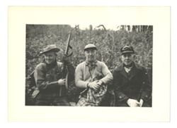 Roy Howard and companions posing with guns
