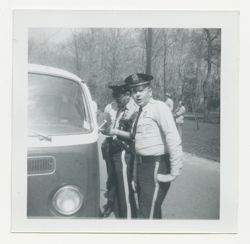 Police officers standing next to van