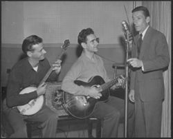 Hoagy Carmichael and unidentified musicians, around an NBC microphone.