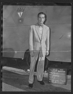 Hoagy Carmichael standing in front of an RKO Radio Pictures' truck in a wardrobe test for the role of "Happy."