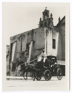 Item 0087. Long shot of coach seen in Items 82-86 above passing by a church. Liceaga is visible seated in the coach.