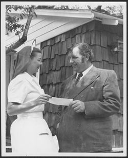 Ruth Carmichael and Andy Devine holding a piece of paper.