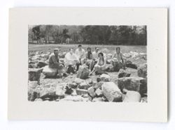Item 1063. Seven people seated amid building stones scattered on the ground. Older man (See Item 1050-1056a above) at far left, Hunter Kimbrough to his left, and two men and three women, all unidentified. Site may be in front of the Temple of the Jaguars. See Items 369 and 370 above. For same group.